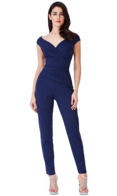 Young women wearing a Bardot Ruched Jumpsuit in Navy. Fabulous bateau cap sleeve neckline makes up this ruched tapered leg jumpsuit from Silhouette London, Girls party dress specialists in London
