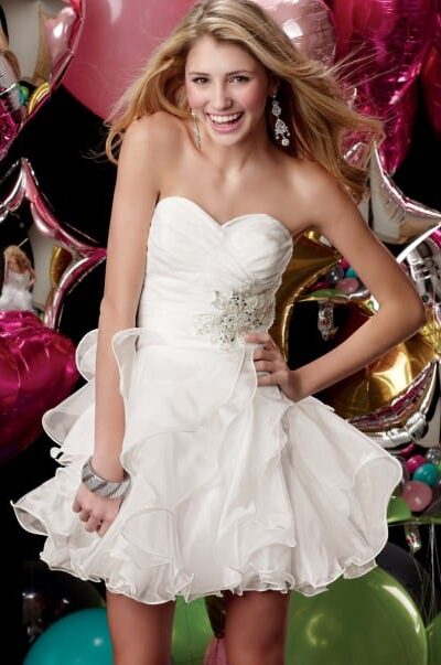Blonde teenage girl wearing a Alyce Paris Dress Style 3545 Ocean. Organza fabric, Strapless, sweetheart neckline with pleated bodice leads to ruffled, tiered skirt from Silhouette London, Girls party dress specialists in London.