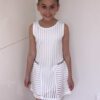 Dress - Style 5884 in Cream 5 Young girl wearing Ivory skater style dress with side chain detail in ladder mesh like fabric from Party Dress Boutique, Silhouette London