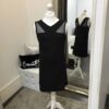 Sally Miller Shannon Dress 4 Mannequin wearing aSally Miller Shannon Dress in Black with Mesh shoulder detail a slight A line shape from Silhouette London Teen Party Fashion Specialists in Greater London