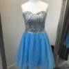 AB Crystal and Tulle Dress 7 AB Crystal and Tulle Dress in turquoise. Irridescent crystals adorn this sweetheart bodice with corset closing and full turquoise tulle skirt with scalloped edge from Silhouette London, Girls party dress specialists in London