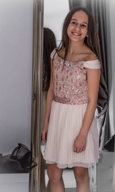 Model wearing Elisa B Ivory embroidered dress from Silhouette London, Girls party dress specialists in London