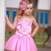 Dolls and Divas Marly Dress 2 Little Girl wearing Dolls and Divas Couture Divas Party Dress Marly 1 with embellished bodice with spaghetti straps, matching satin bow and full tulle skirt in Pink from Girls Party Dress Boutique Silhouette London