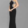 Pre-Loved Tiffany Illusion Prom Nancy Dress Black 3 Blonde teenage girl wearing a Tiffany Illusion Prom Nancy Dress. Halter neck jersey dress with slinky skirt, crystal embellishment and gorgeous cut out sides from Prom Dress Boutique Silhouette London.