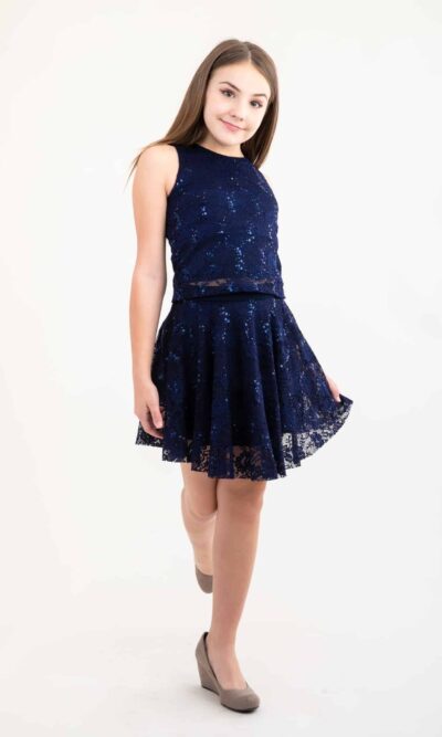 Teenage Girl wearing a Navy Lace and Sequin Skater Skirt with matching top from Silhouette London, a Girls Party Dress Boutique in Greater London