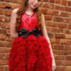Ooh la la Couture Wow Dream Dress (Red) 2 Young Girl wearing anOoh la la Couture Wow Dream Dress in Red with Black Bow from Silhouette London a Girls Party Dress Specialist Boutique in Greater London