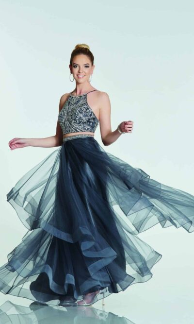 Teenage model wearing a Tiffany Illusion Prom Trinity Two Piece Dress in Charcoal. Fabulous two piece with crystal encrusted halter neck bodice and wonderfully full long tiered tulle skirt with banded edges from Prom Dress Boutique Silhouette London